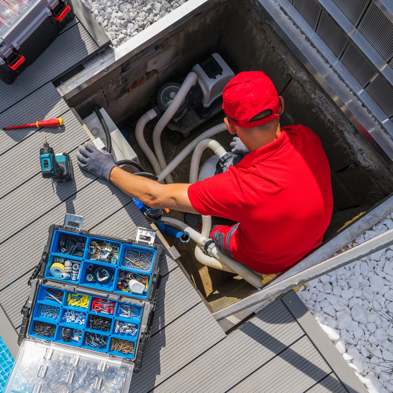 man doing maintenance on pool equipment